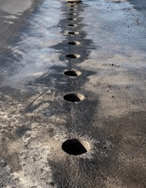 Multiple core samples drilled in pavement for structural analysis